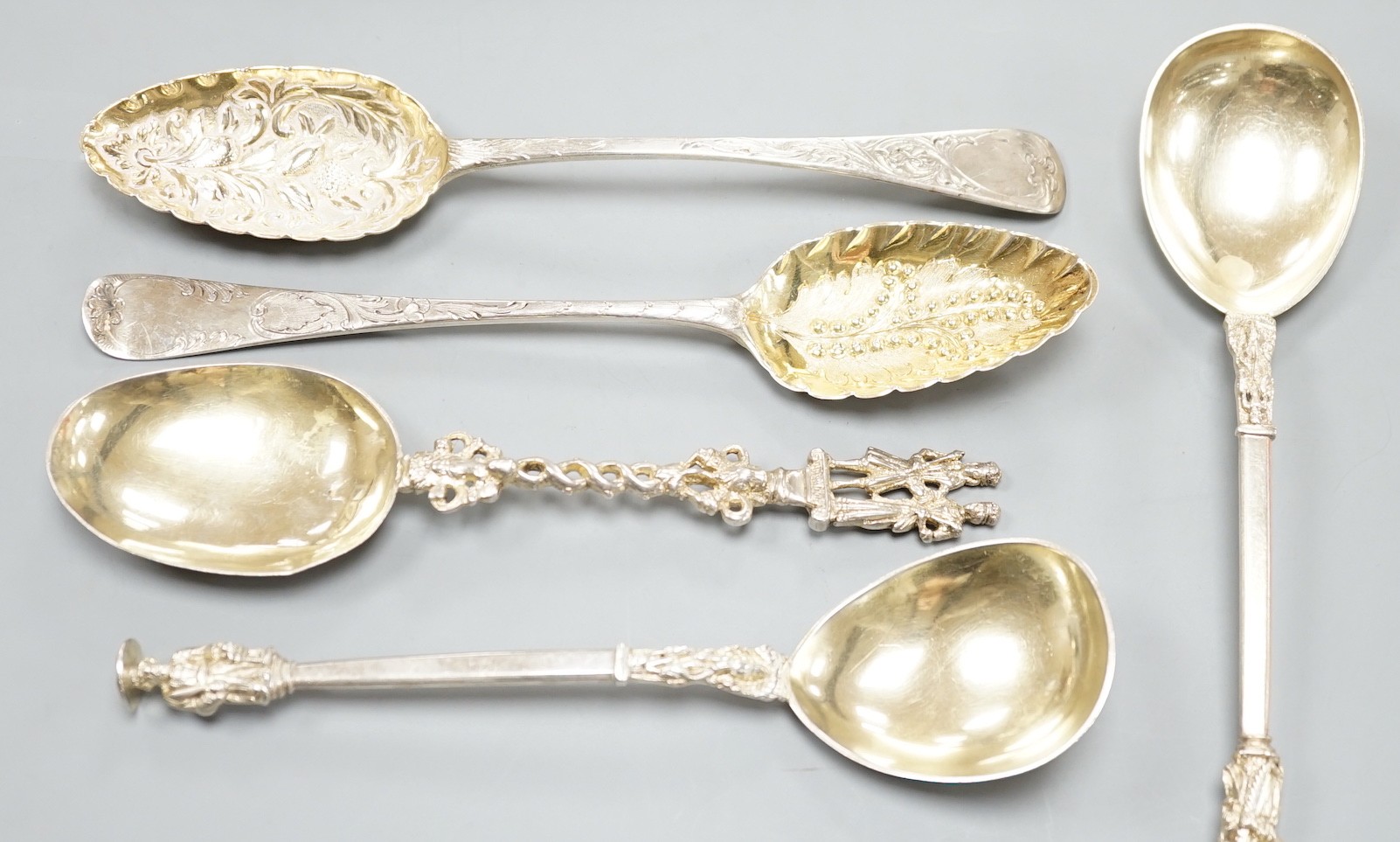 Two George III silver 'berry spoons', a pair of Victorian silver apostle serving spoons, Josiah Williams & Co, London, 1888, 19.8cm and a continental white metal spoon.